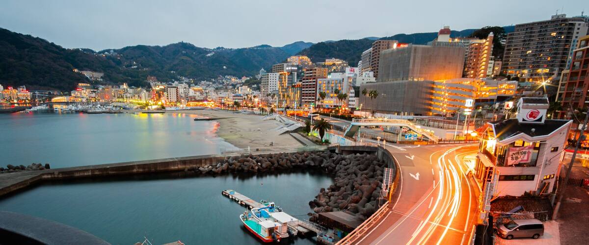 Atami showing a bay or harbor, night scenes and a coastal town
