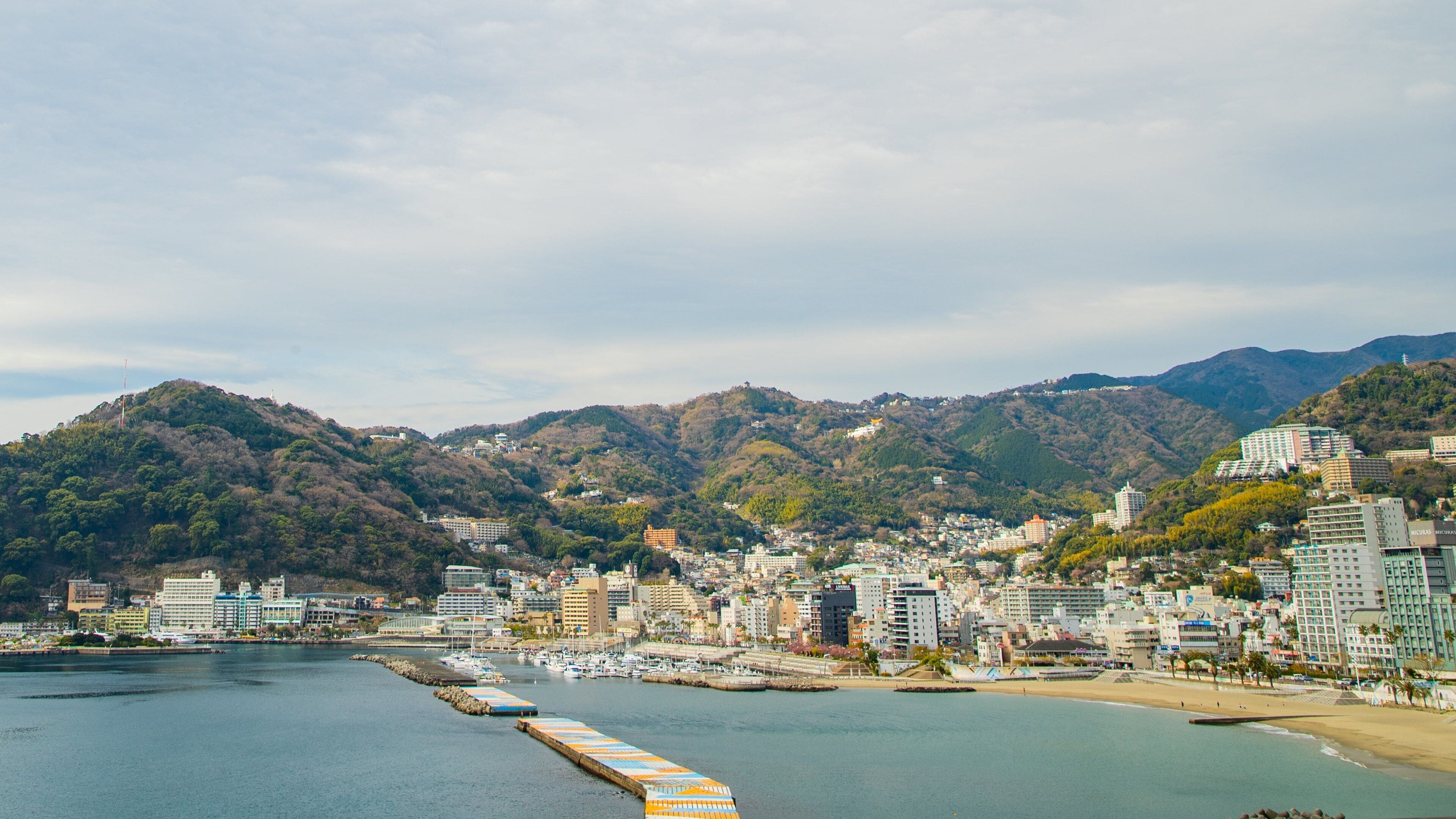 Atami which includes a bay or harbor and a coastal town