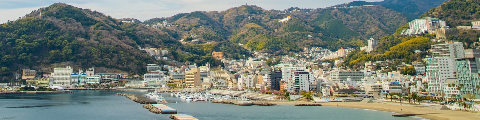 Atami which includes a bay or harbor and a coastal town