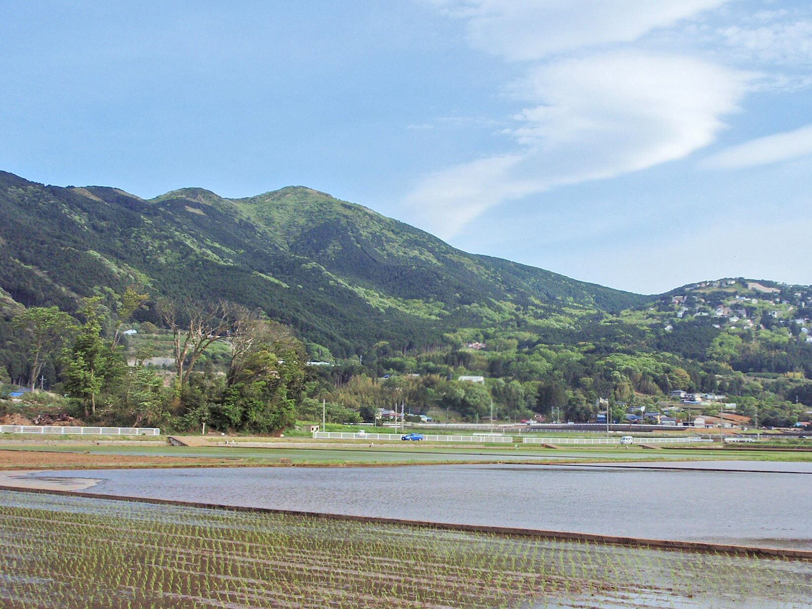 A mountainous landscape with terraced fields and a clear sky.