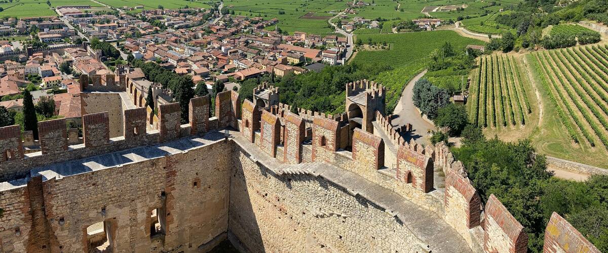 A historic town with medieval walls and terraced vineyards.