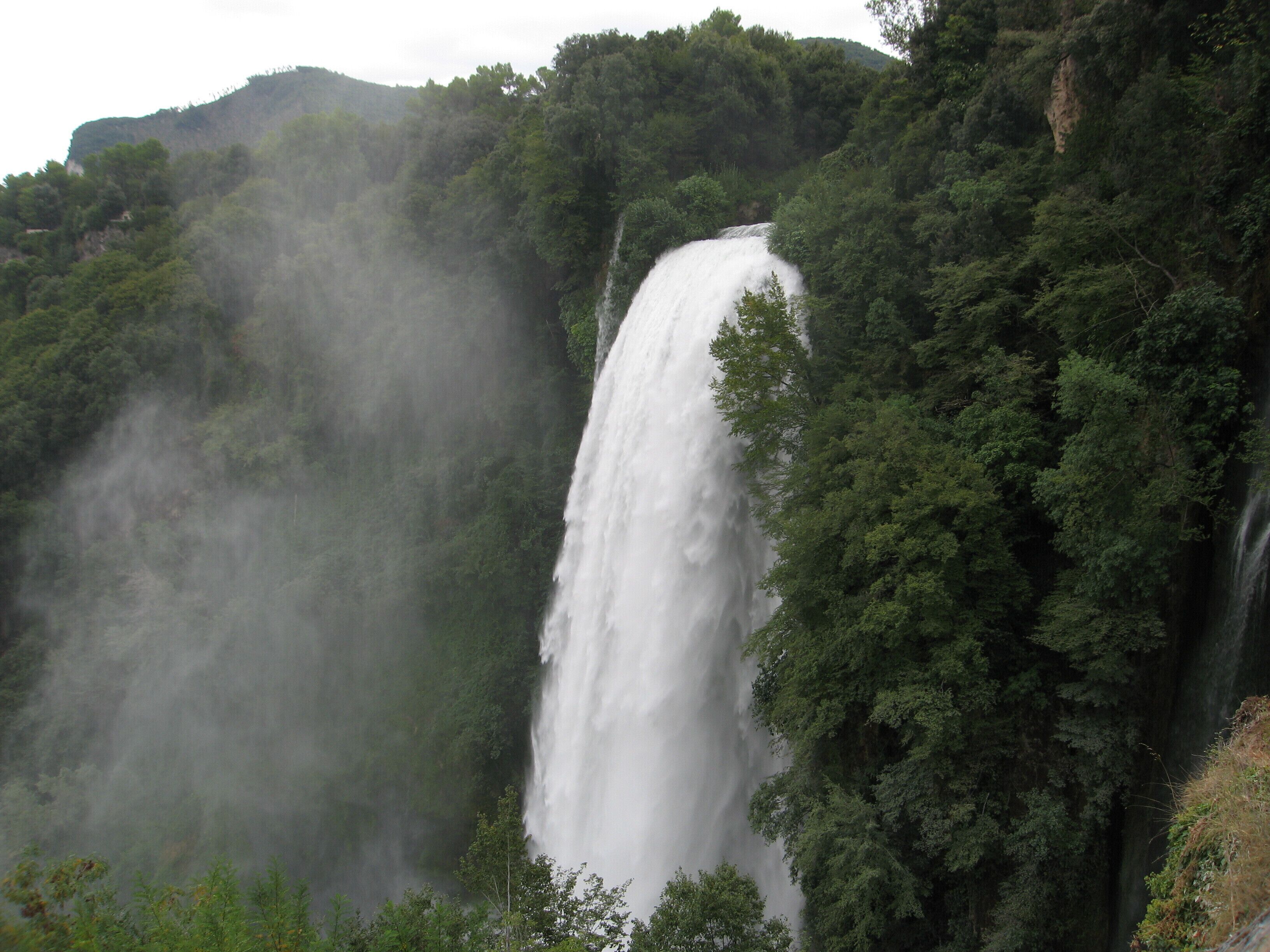 A large waterfall surrounded by dense forest.