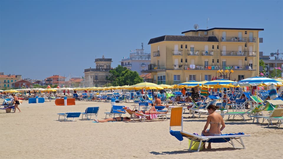A crowded beach with numerous sun loungers and umbrellas.
