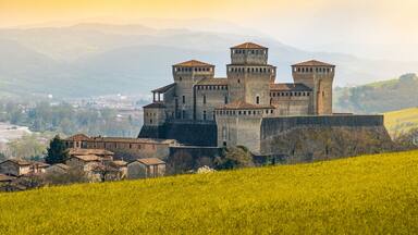 landmarks of italy, the Torrechiara fantasy castle near Parma - Italy with yellow warm toned grass and sky vintage look with copy space