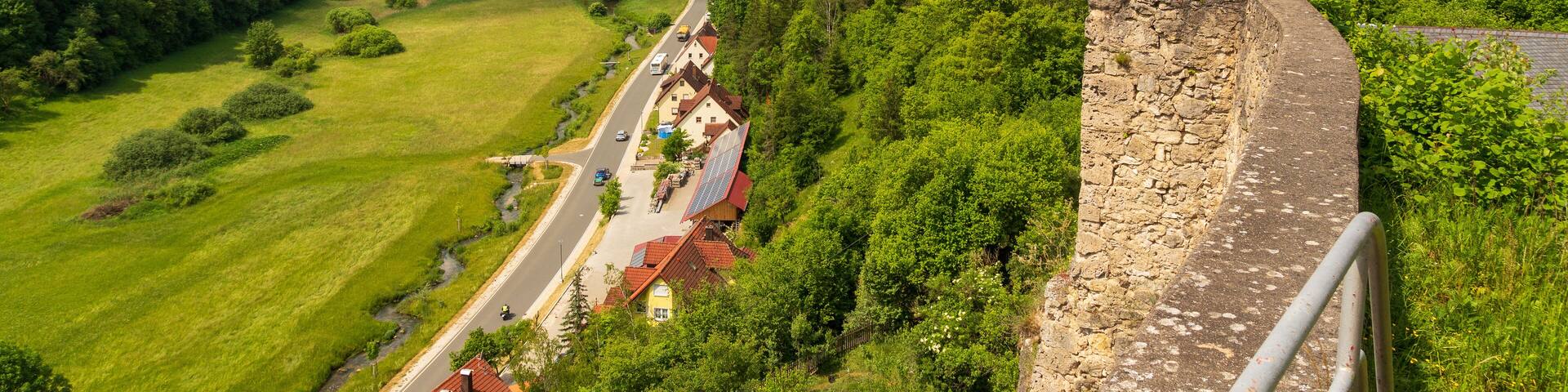 Ruins of Wolfsberg Castle and hill panorama with street near Obertrubach in Franconian Switzerland, Germany