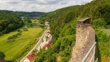 Ruins of Wolfsberg Castle and hill panorama with street near Obertrubach in Franconian Switzerland, Germany