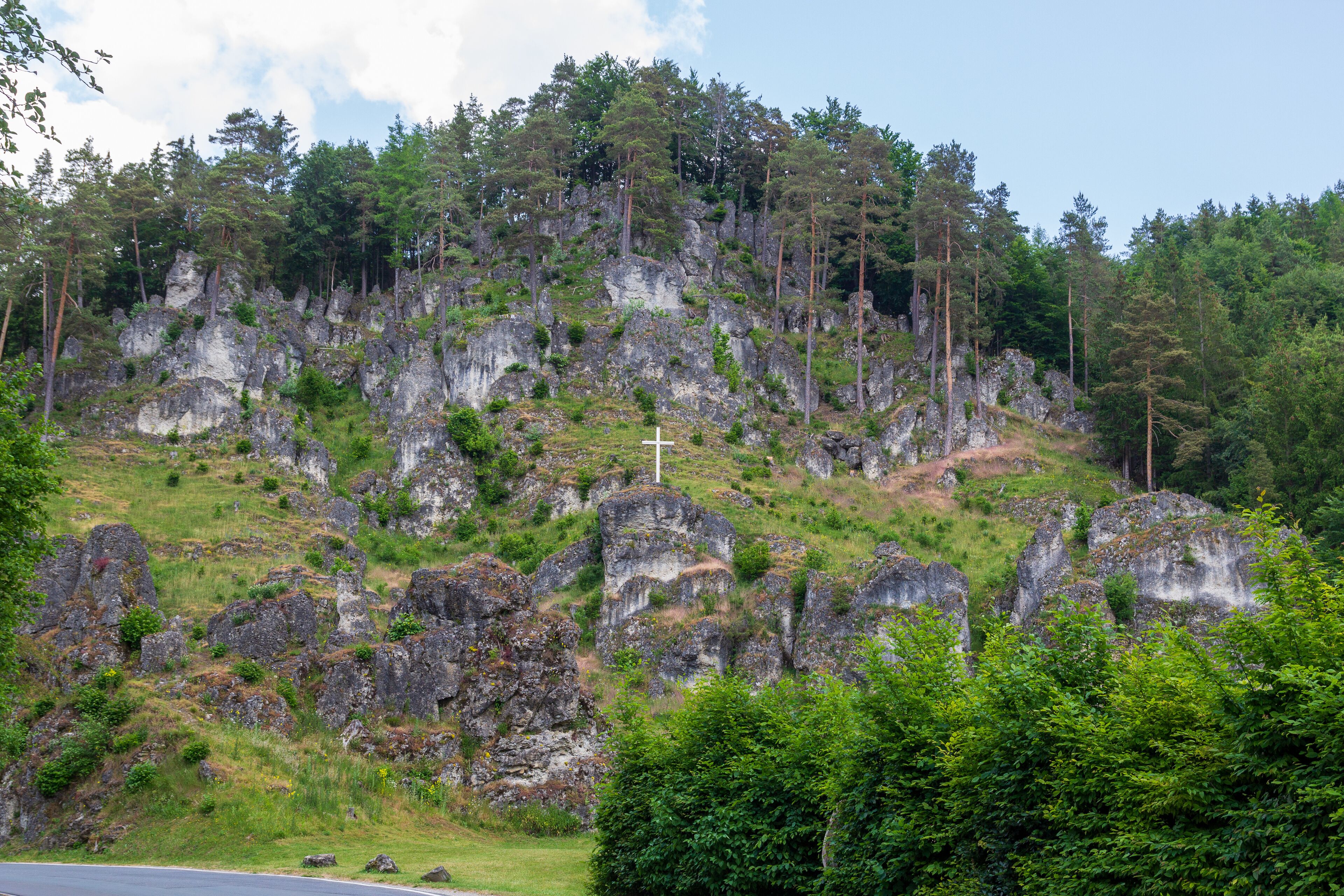 Climbing rock Altarstein with summit cross in Obertrubach in Franconian Switzerland, Germany
