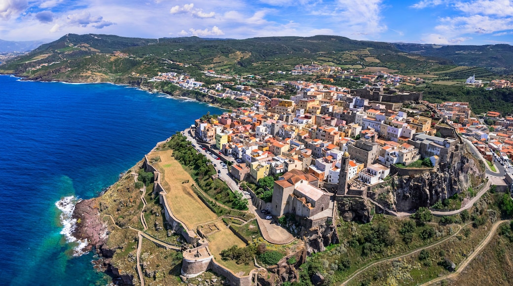 Aerial drone panoramic view of Castelsardo medieval coastal town in Sardinia. Picturesque colorful houses & historic castle in Sassari province. Authentic Italian resort architecture, north Sardegna.