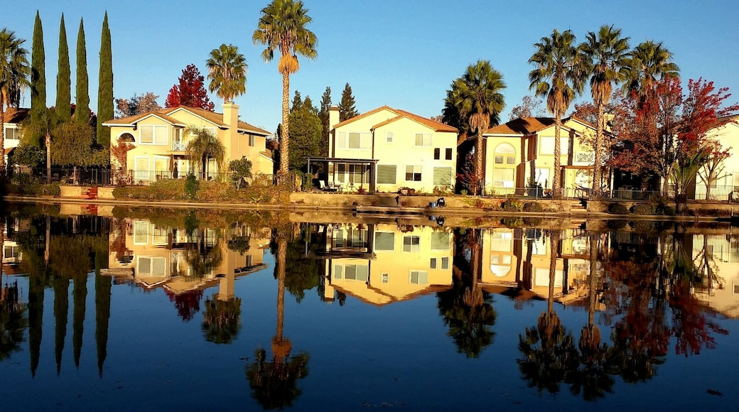 Beautiful sunrise as houses in Elk Grove were reflecting in the clear water of the man-made lake in their front yard.