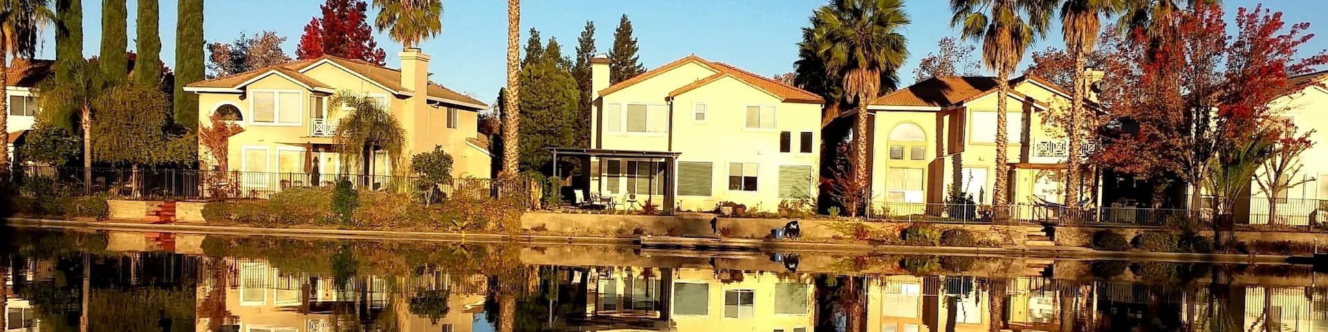 Beautiful sunrise as houses in Elk Grove were reflecting in the clear water of the man-made lake in their front yard.