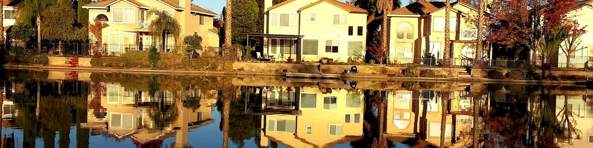 Beautiful sunrise as houses in Elk Grove were reflecting in the clear water of the man-made lake in their front yard.