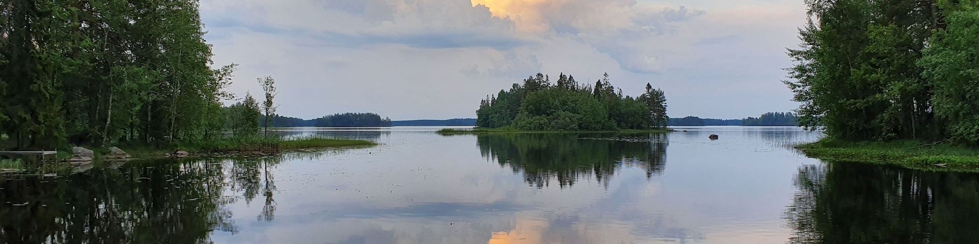 Reflection of trees and clouds on lake