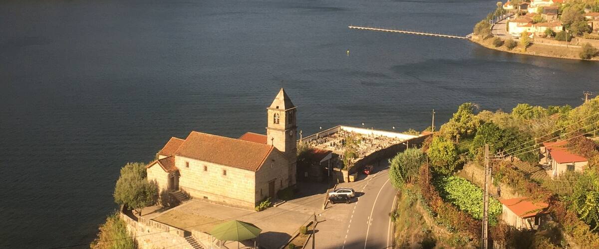 A river with a church and a bridge.