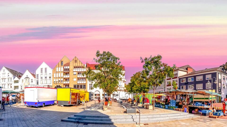 A European market square with historic buildings and vendors.