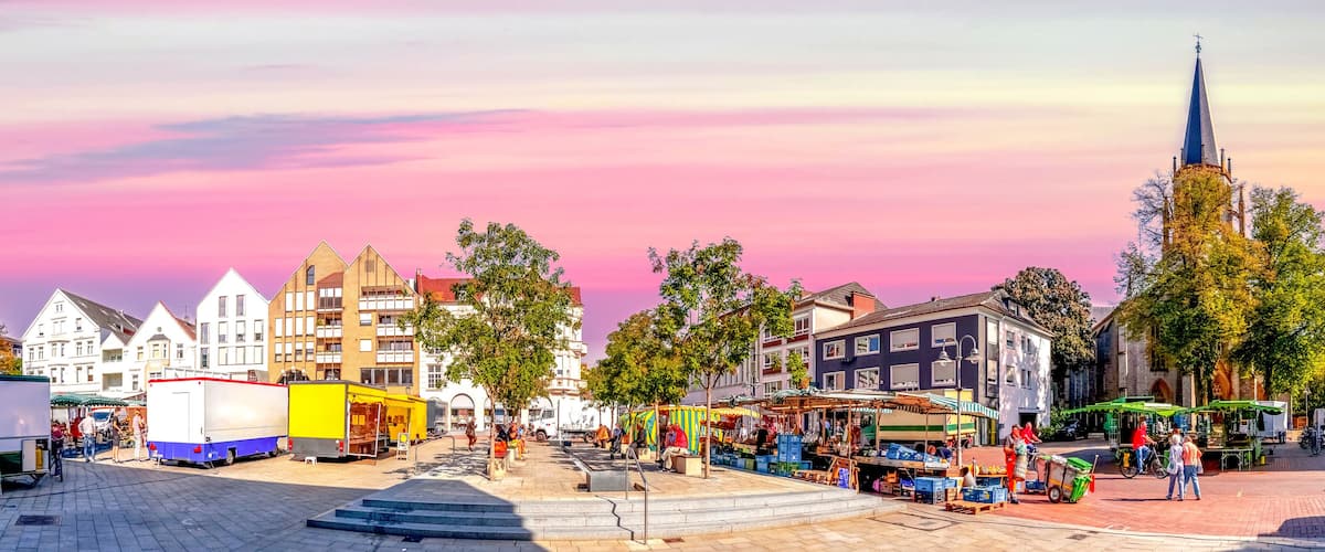 A European market square with historic buildings and vendors.