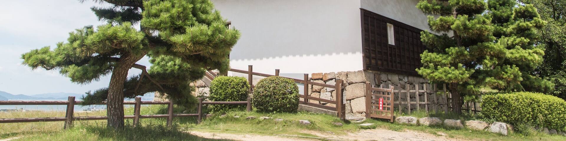 Low angle shot of the magnificent Uwajima Castle captured under the blue sky in Japan