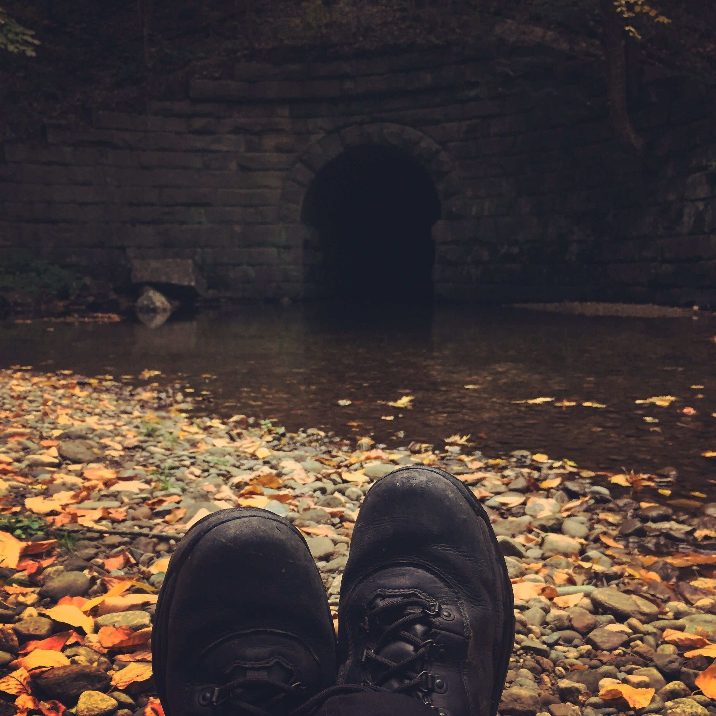 Enjoying the relaxing sounds of the stream slowly working its way under an old rail bridge in Northfield.