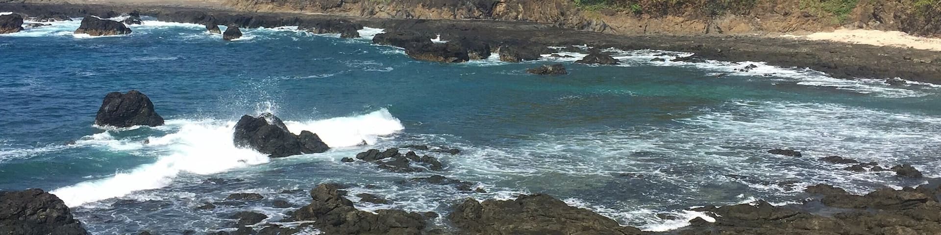 Drive on dirt roads and through rivers forever to get to this beautiful almost-private beach. Couple little shops in "town" for coffee & snacks.