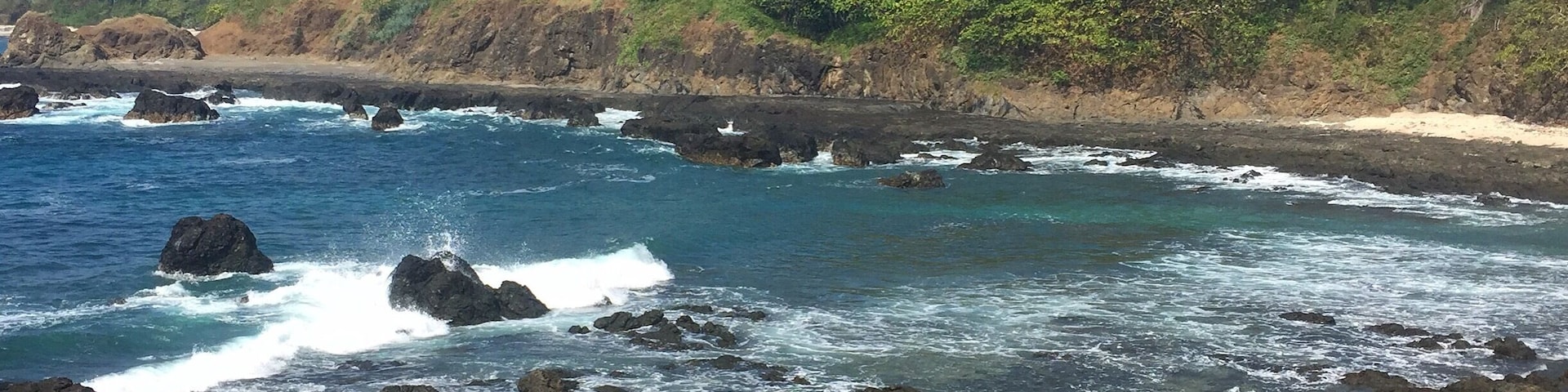 Drive on dirt roads and through rivers forever to get to this beautiful almost-private beach. Couple little shops in "town" for coffee & snacks.