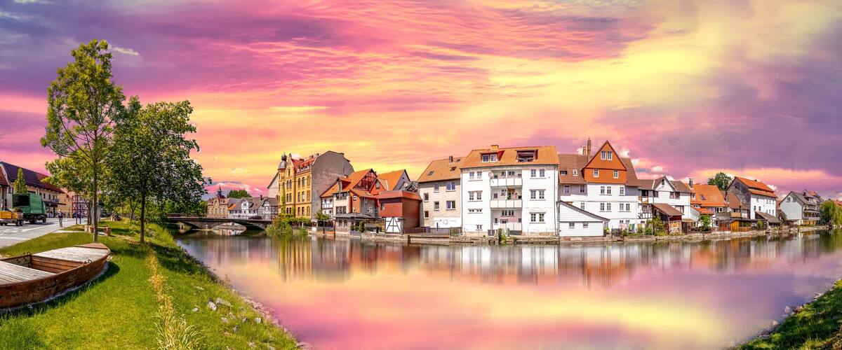 A riverside town with historic buildings and a bridge.