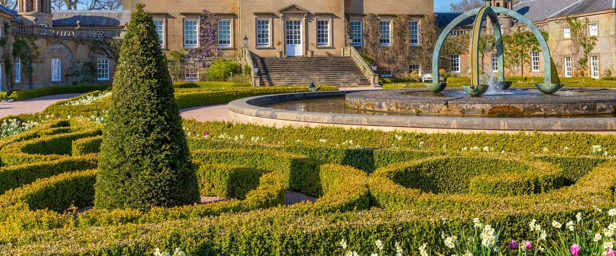 Dumfries House features the Mahtouz fountain and garden in Cumnock, highlighting the lush greenery and historic architecture of Scotland