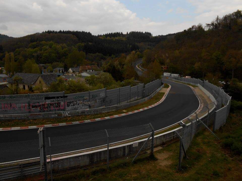A one of a kind track where you see alot of nice cars in a backdrop of the forest. 