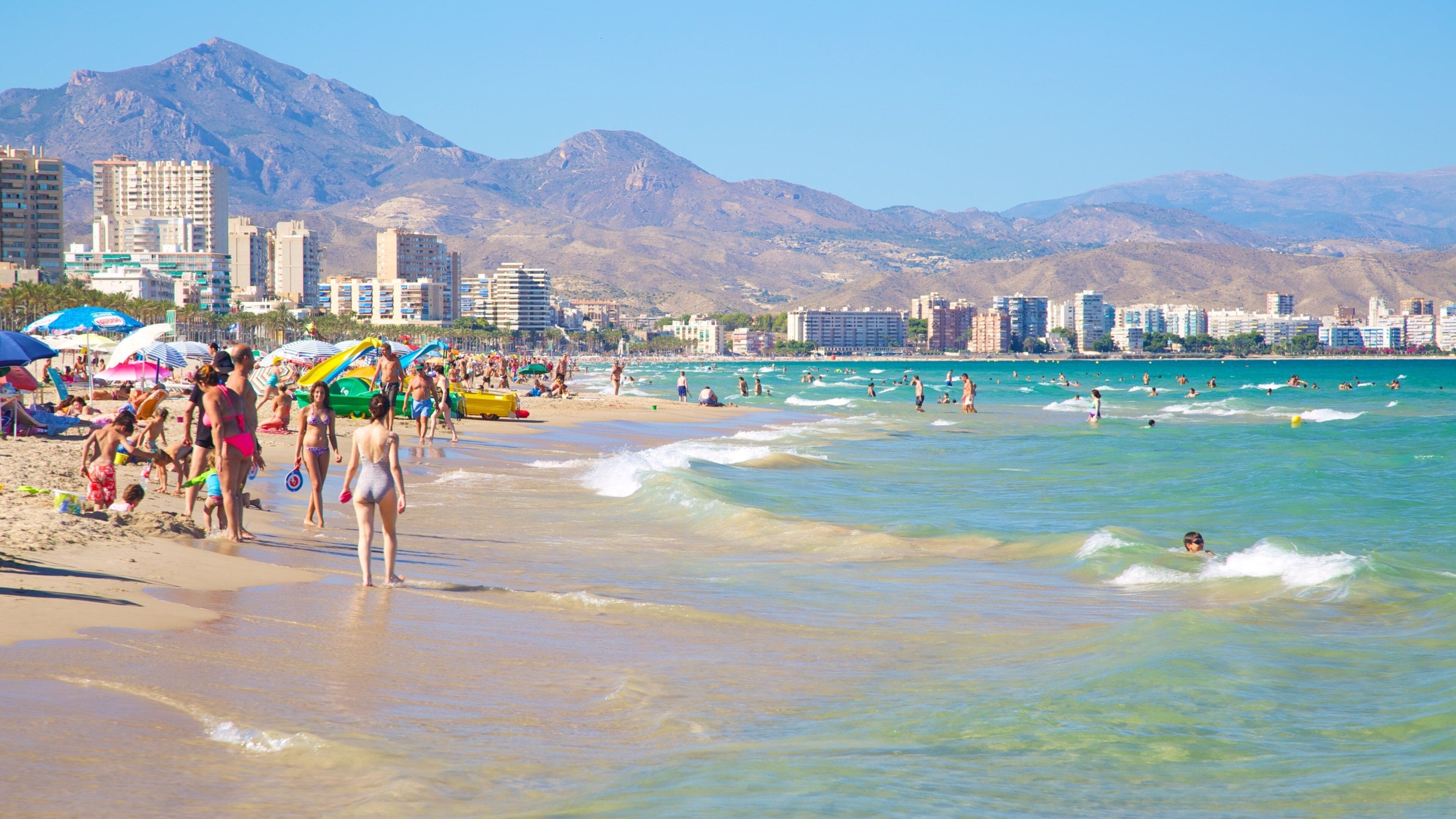 Alicante showing a coastal town, a beach and swimming