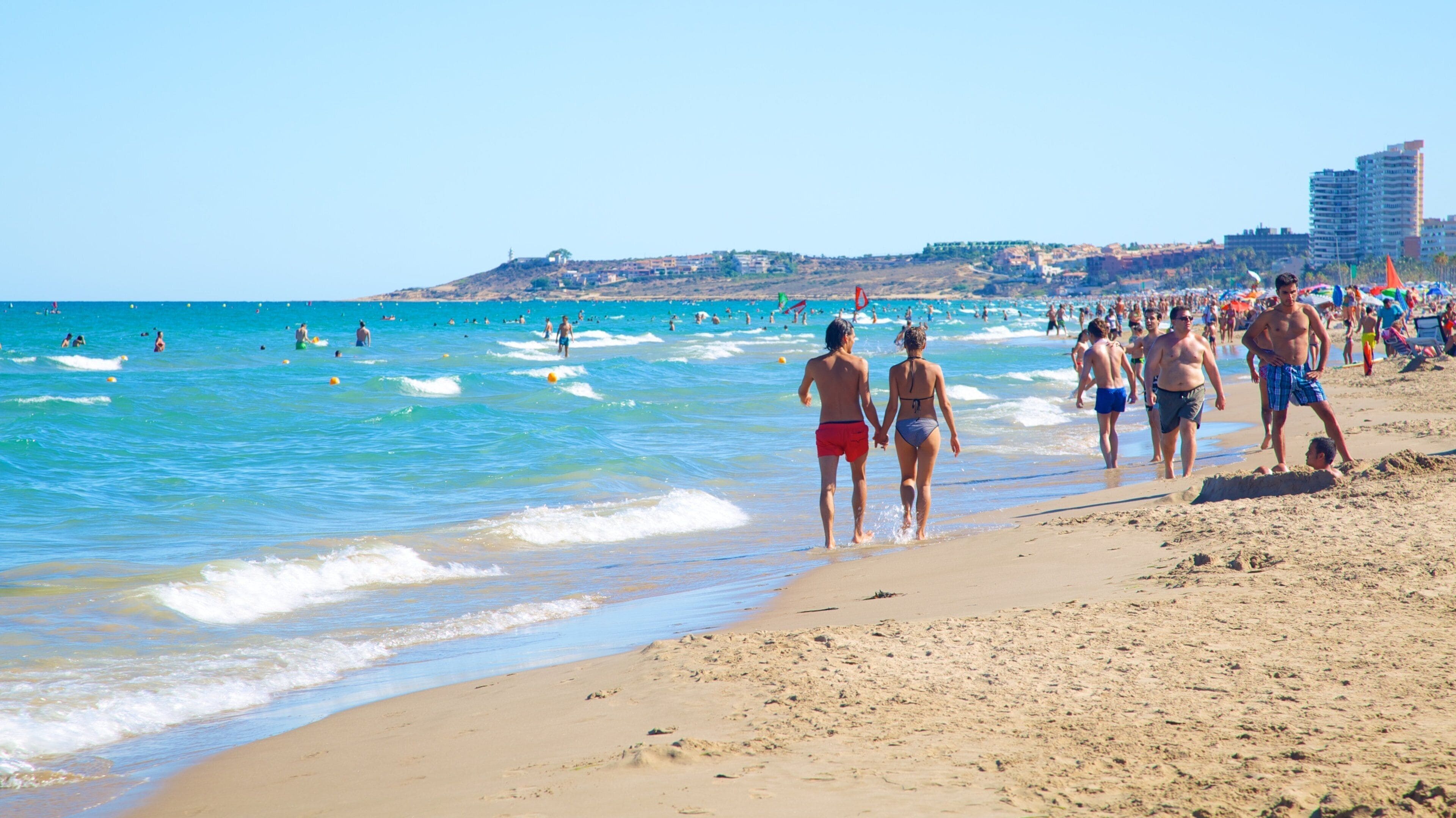 Alicante featuring a beach and swimming as well as a large group of people