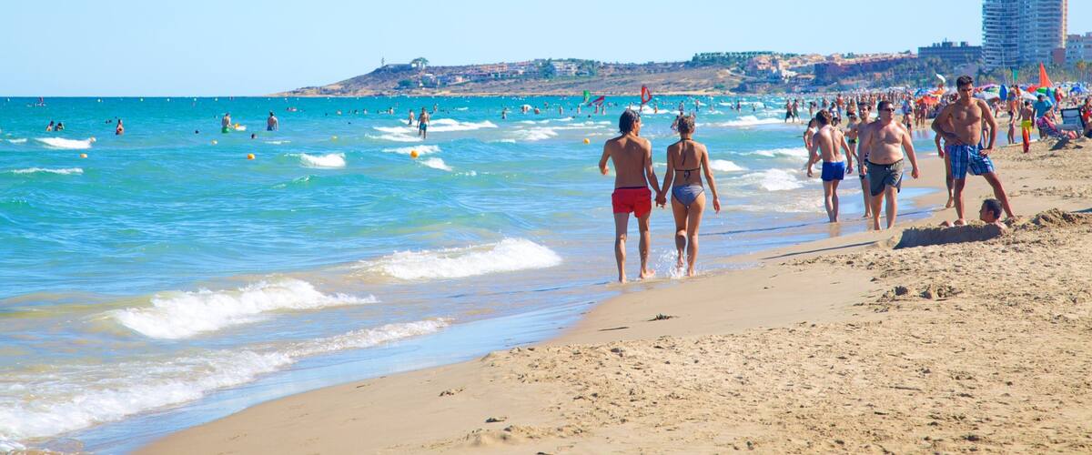 Alicante which includes a sandy beach and swimming as well as a large group of people