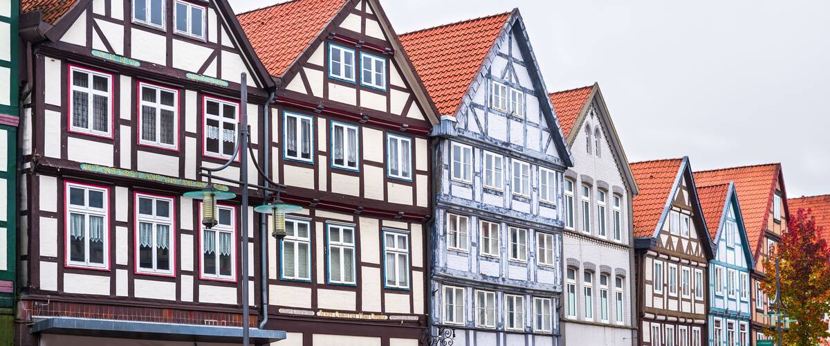 A row of traditional half-timbered houses with red tiled roofs.