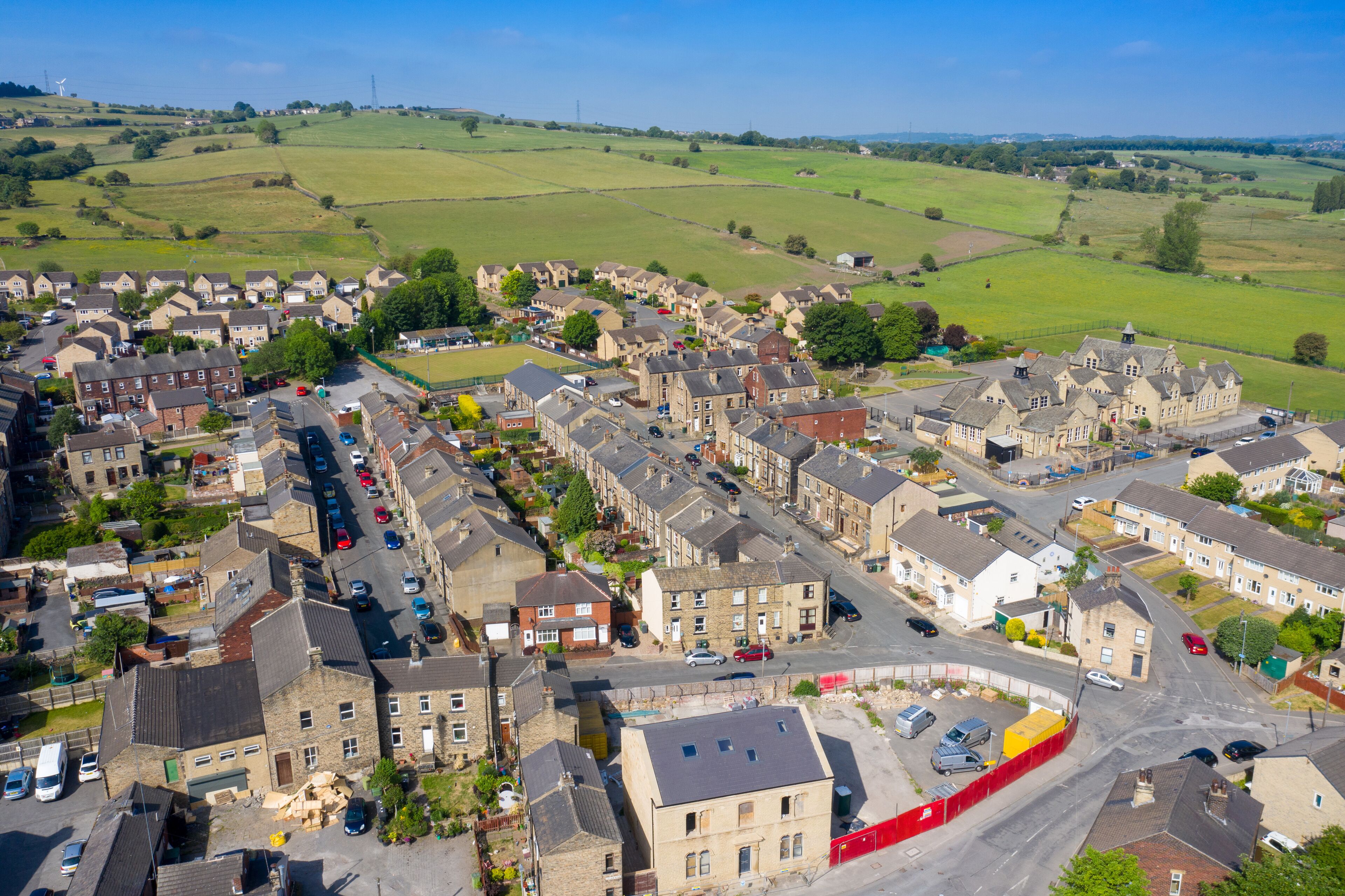 Aerial drone photo of the beautiful town of Mirfield in Kirklees, West Yorkshire, England showing the village houses on a beautiful sunny summers day