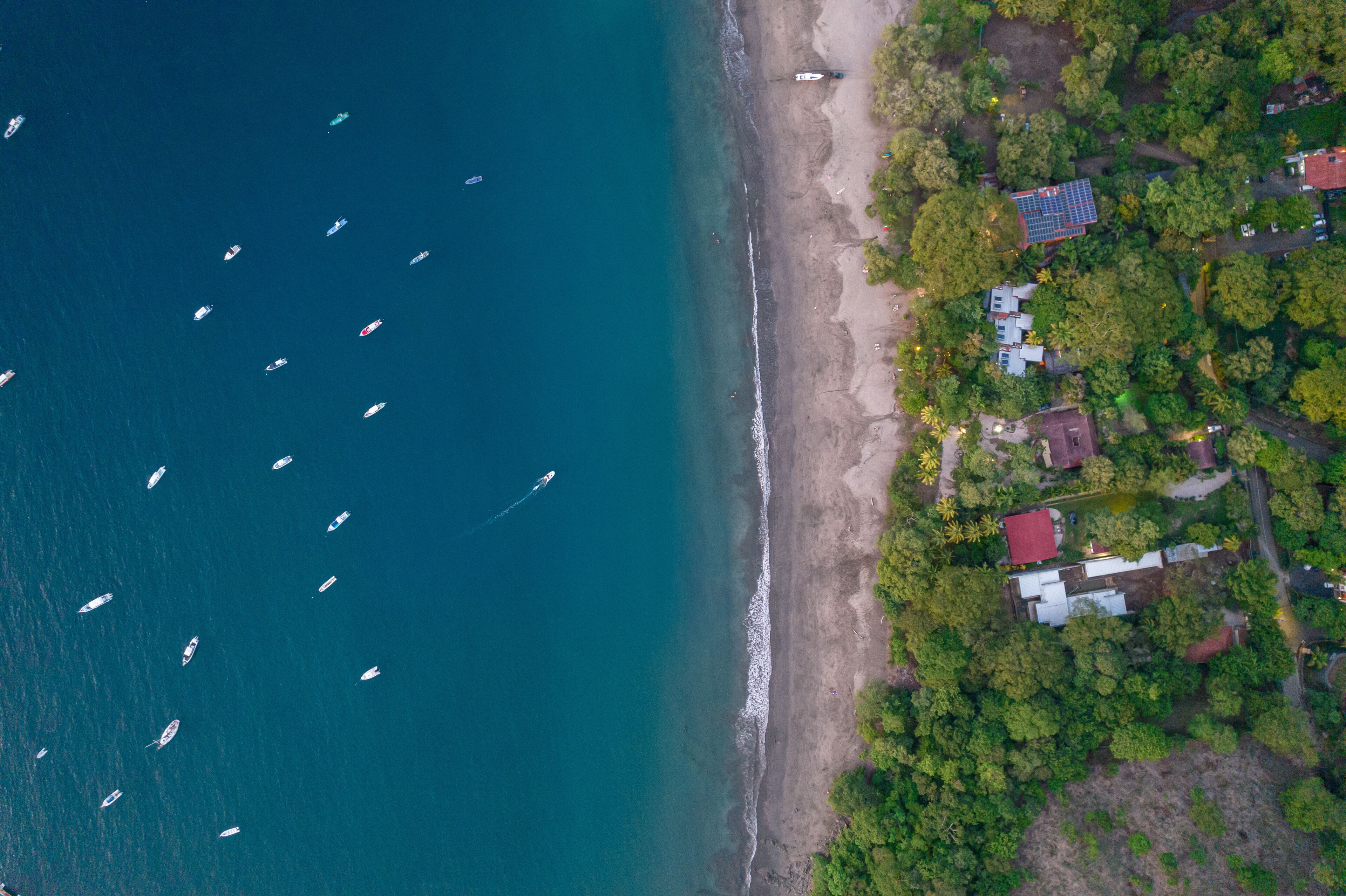 A coastal area with boats on the water and houses near the shore.