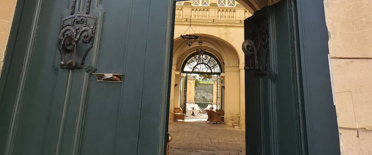 A blue ornate entrance with a decorative archway and a sign indicating a no parking zone.