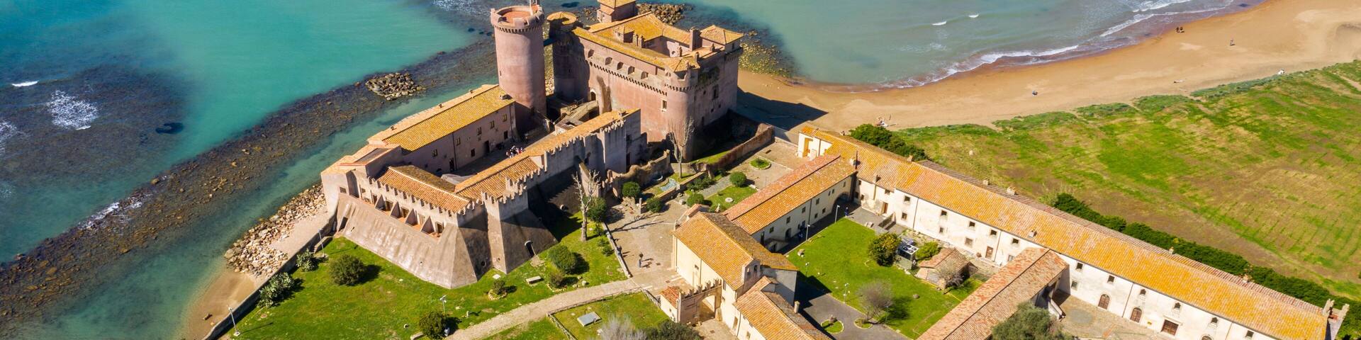 Aerial view of the Castle of Santa Severa, located in Santa Marinella in Lazio, in the Metropolitan City of Rome, Italy. It is a medieval castle built on the beach and overlooking the Tyrrhenian Sea.