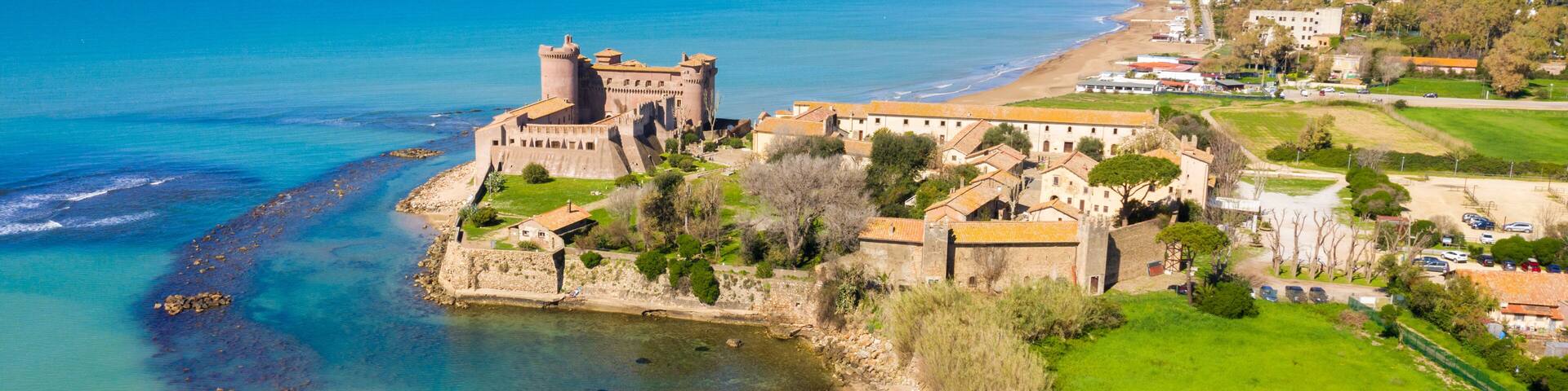 Aerial view of the Castle of Santa Severa, located in Santa Marinella in Lazio, in the Metropolitan City of Rome, Italy. It is a medieval castle built on the beach and overlooking the Tyrrhenian Sea.