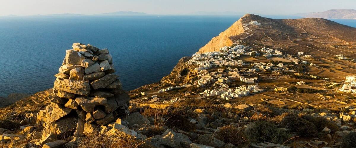 A coastal village with stone structures and a clear view of the sea.