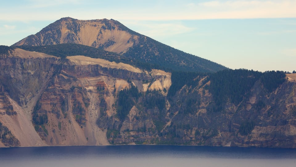 A mountain range with a lake in the foreground.