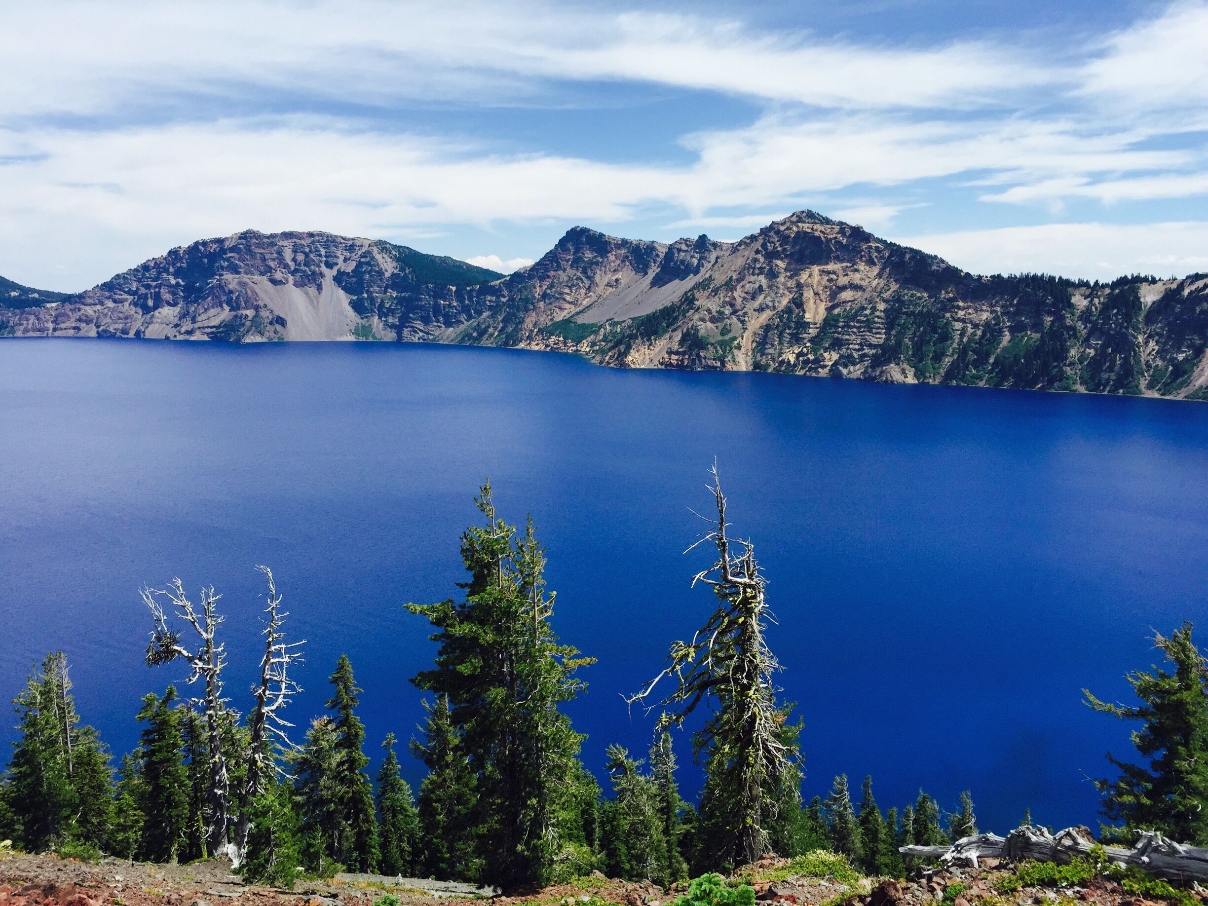 Deep , pure lake , indigo blue in color surrounded by cliffs with a violent volcanic past . It has to be experienced to feel it . #waterlust #craterlake #bluewaters #deepestlake #purest 