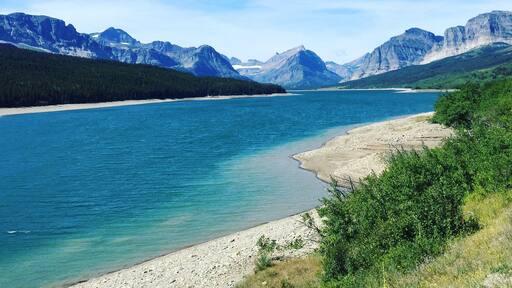 We stumbled upon this amazing view of the mountains and pristine blue water on our way to St. Mary Lake. #mountains #bluewater