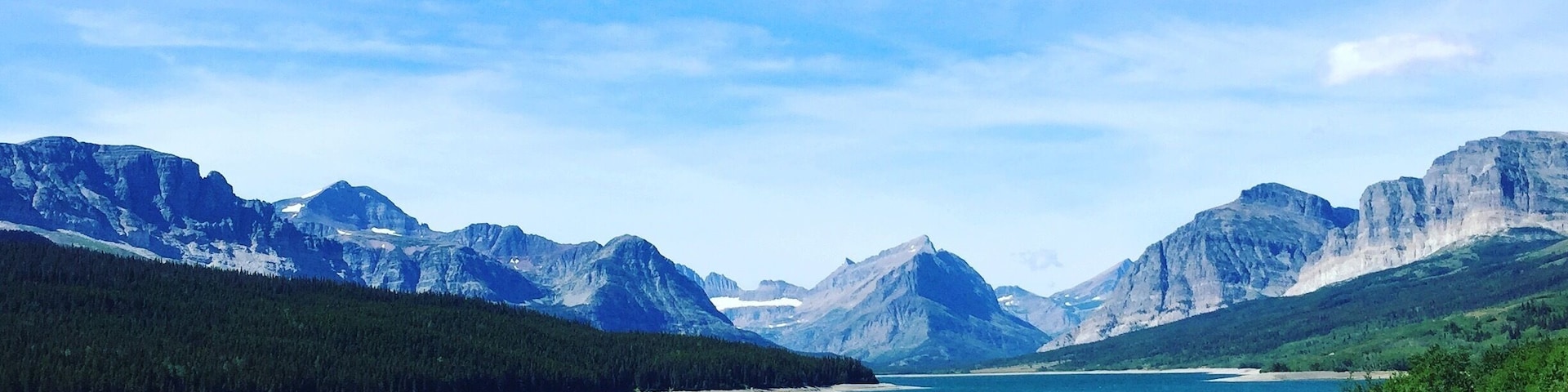 We stumbled upon this amazing view of the mountains and pristine blue water on our way to St. Mary Lake. #mountains #bluewater
