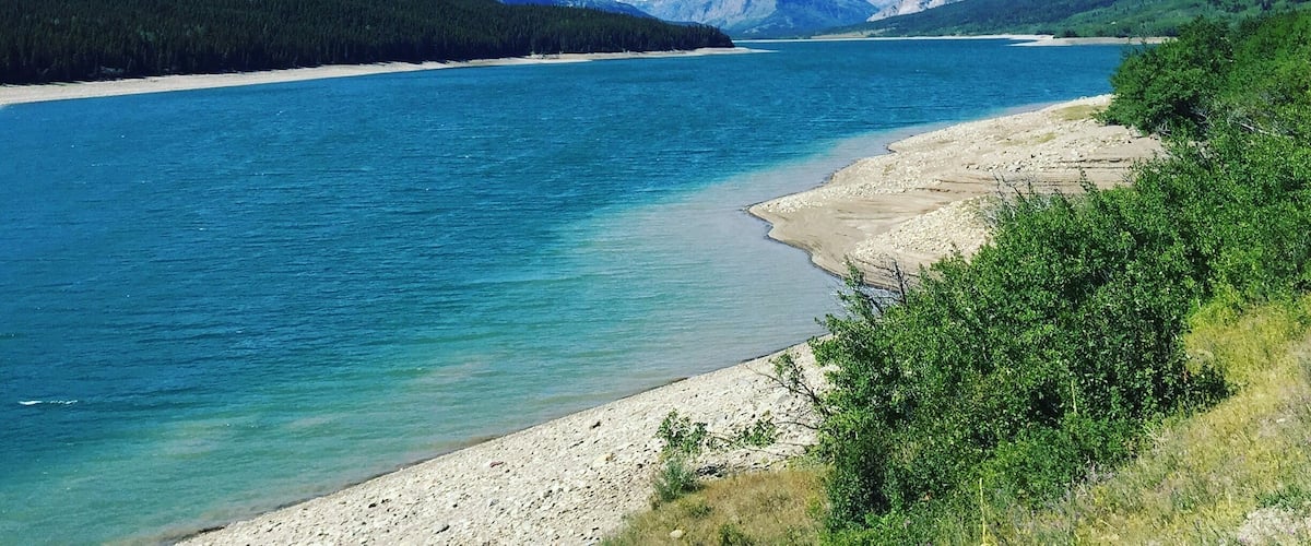 We stumbled upon this amazing view of the mountains and pristine blue water on our way to St. Mary Lake. #mountains #bluewater