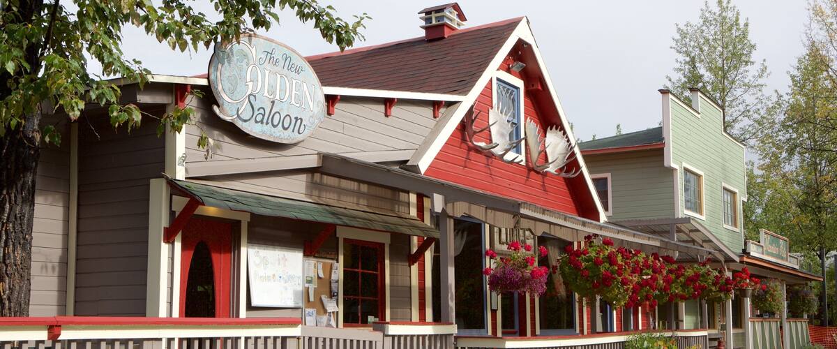 A building with a sign reading "The New Golden Saloon."
