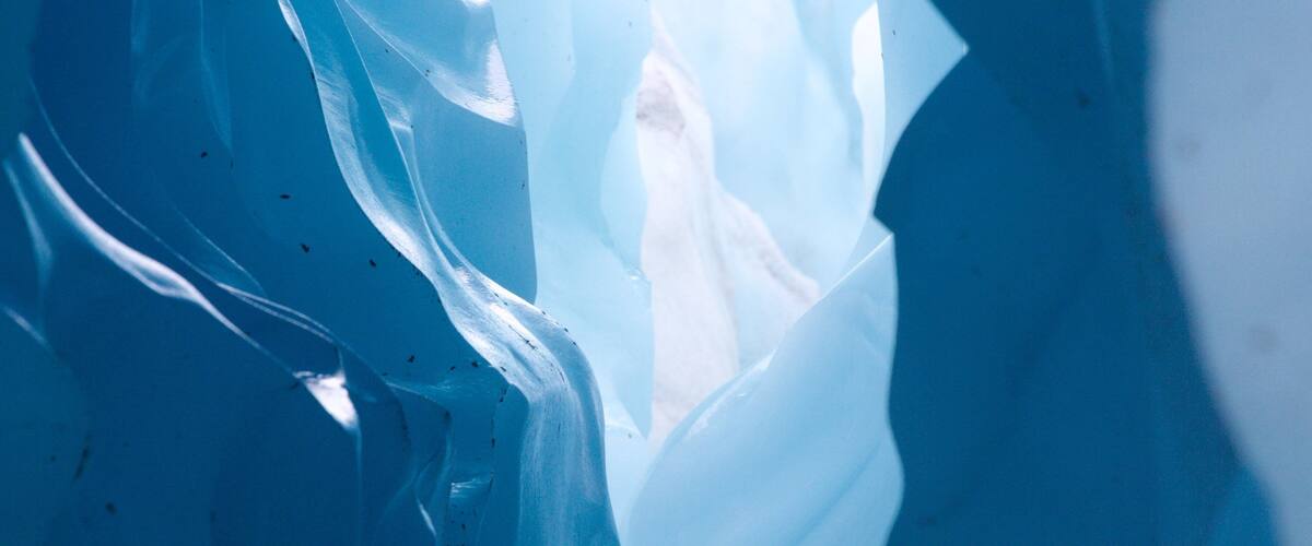 A close-up of ice formations with visible cracks and crevices.