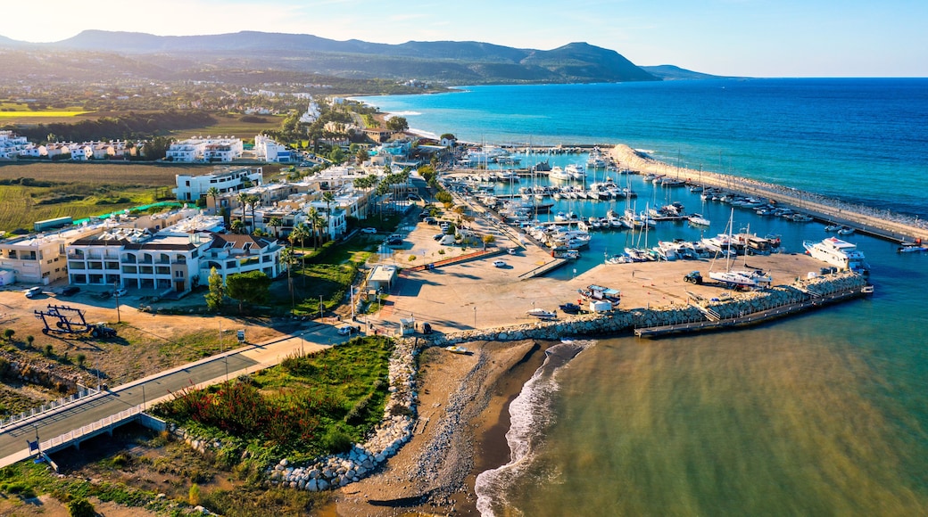 View of Latchi port, Akamas peninsula, Polis Chrysochous, Paphos, Cyprus. The Latsi harbour with boats and yachts, fish restaurant, promenade, beach tourist area and mountains, Latchi, Cyprus.