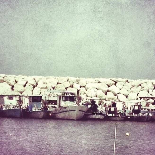 Fishing boats lined up along the harbour wall at Latchi. Photo taken from the Sea Crest Restaurant