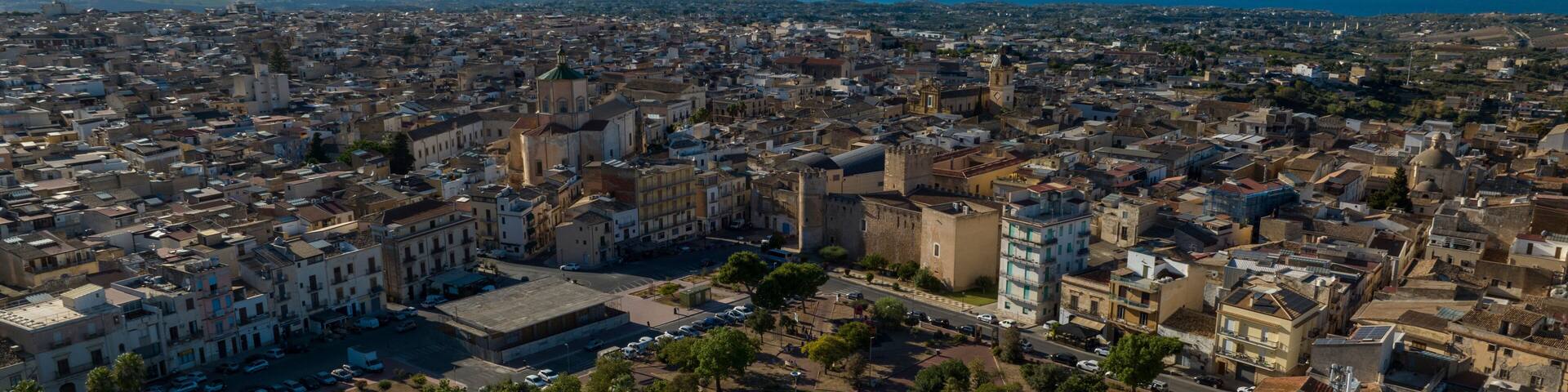 Aerial view of the main square of Alcamo, a city located in the province of Trapani, Sicily, Italy. In the background is the Gulf of Castellammare and the Mediterranean Sea.