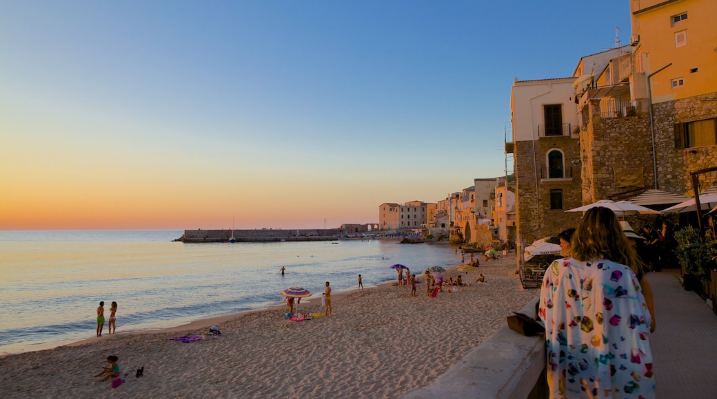 Cefalu featuring a coastal town, a sunset and a sandy beach