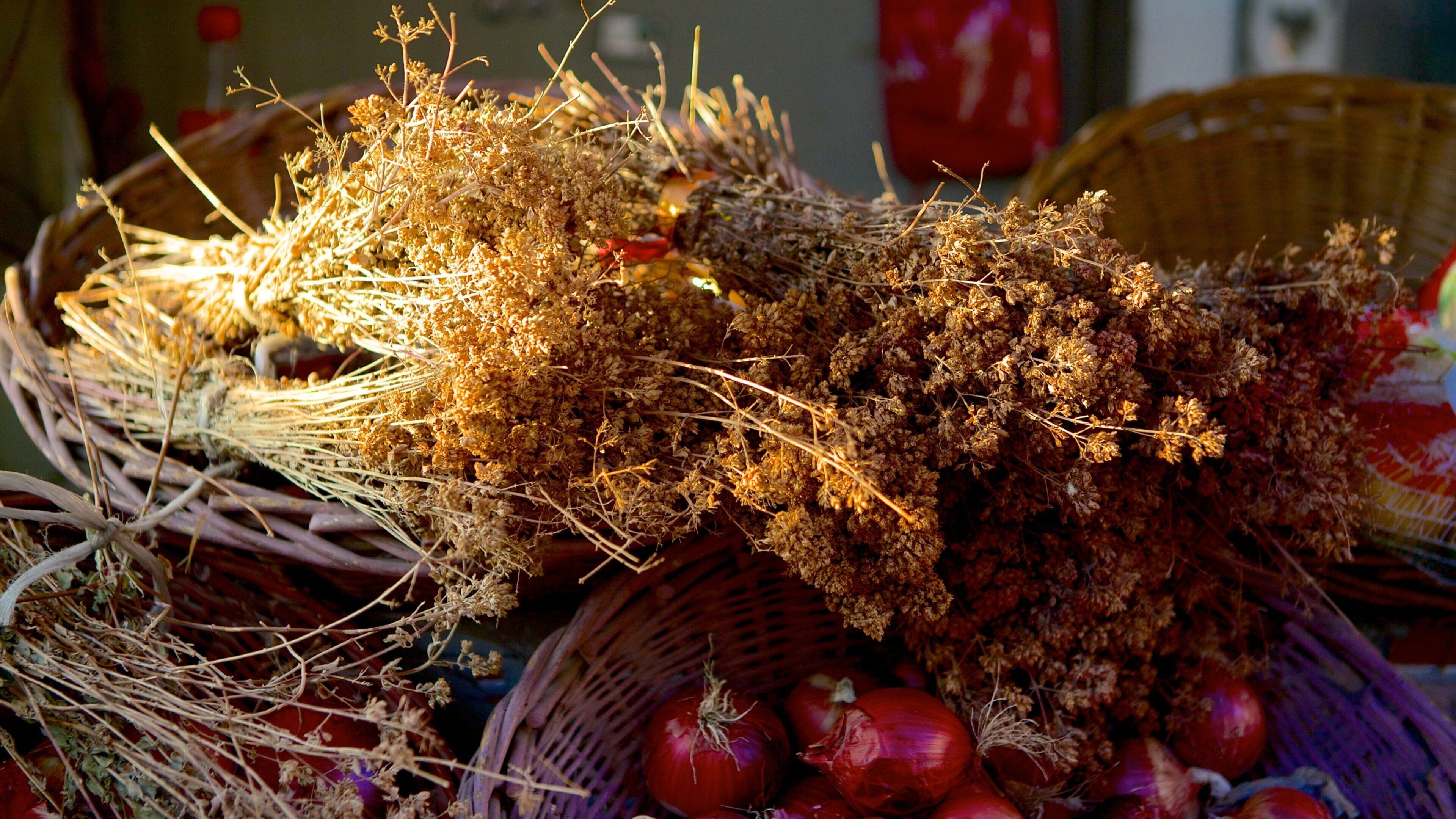 A basket of dried herbs and onions.