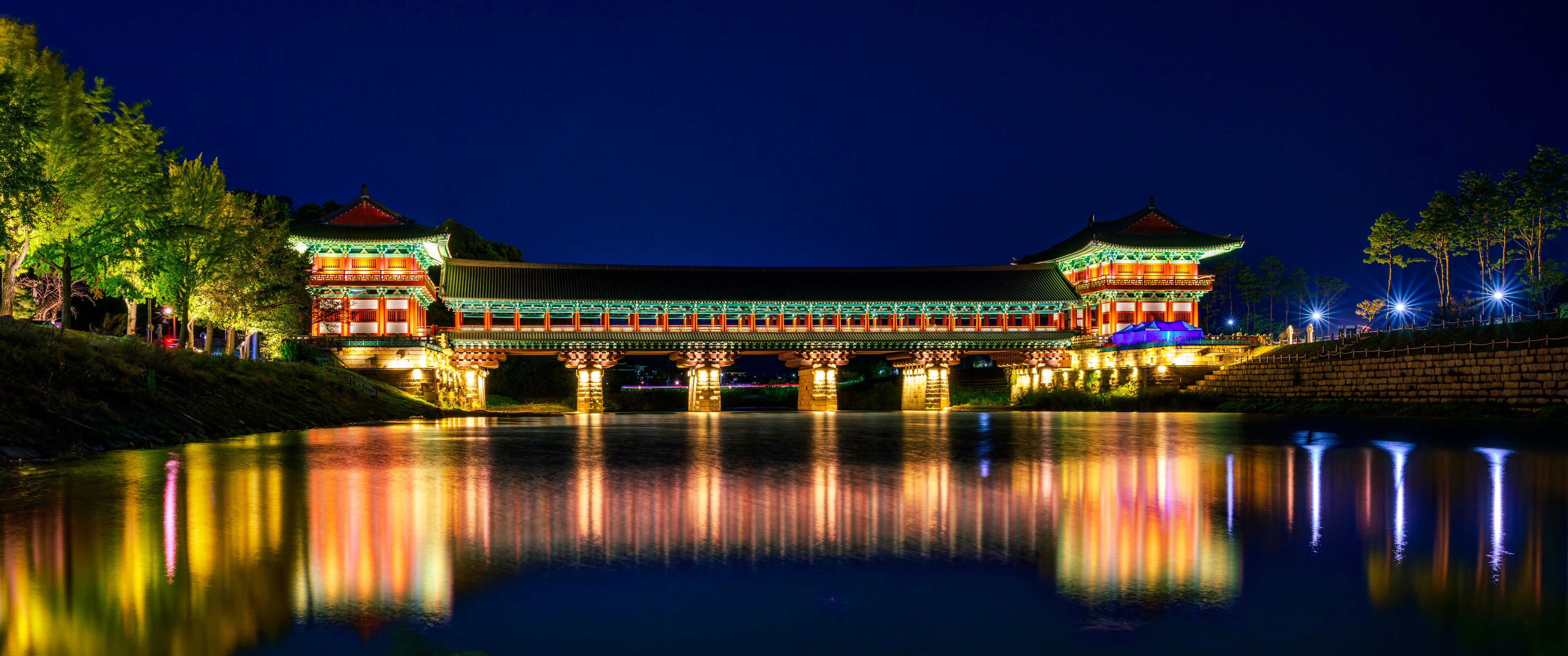 The vibrant beautiful Woljeong Bridge in Gyeongju City, the ornate architecture of the Silla Dynasty, illuminated at night with water reflections on Namcheon or South River in South Korea