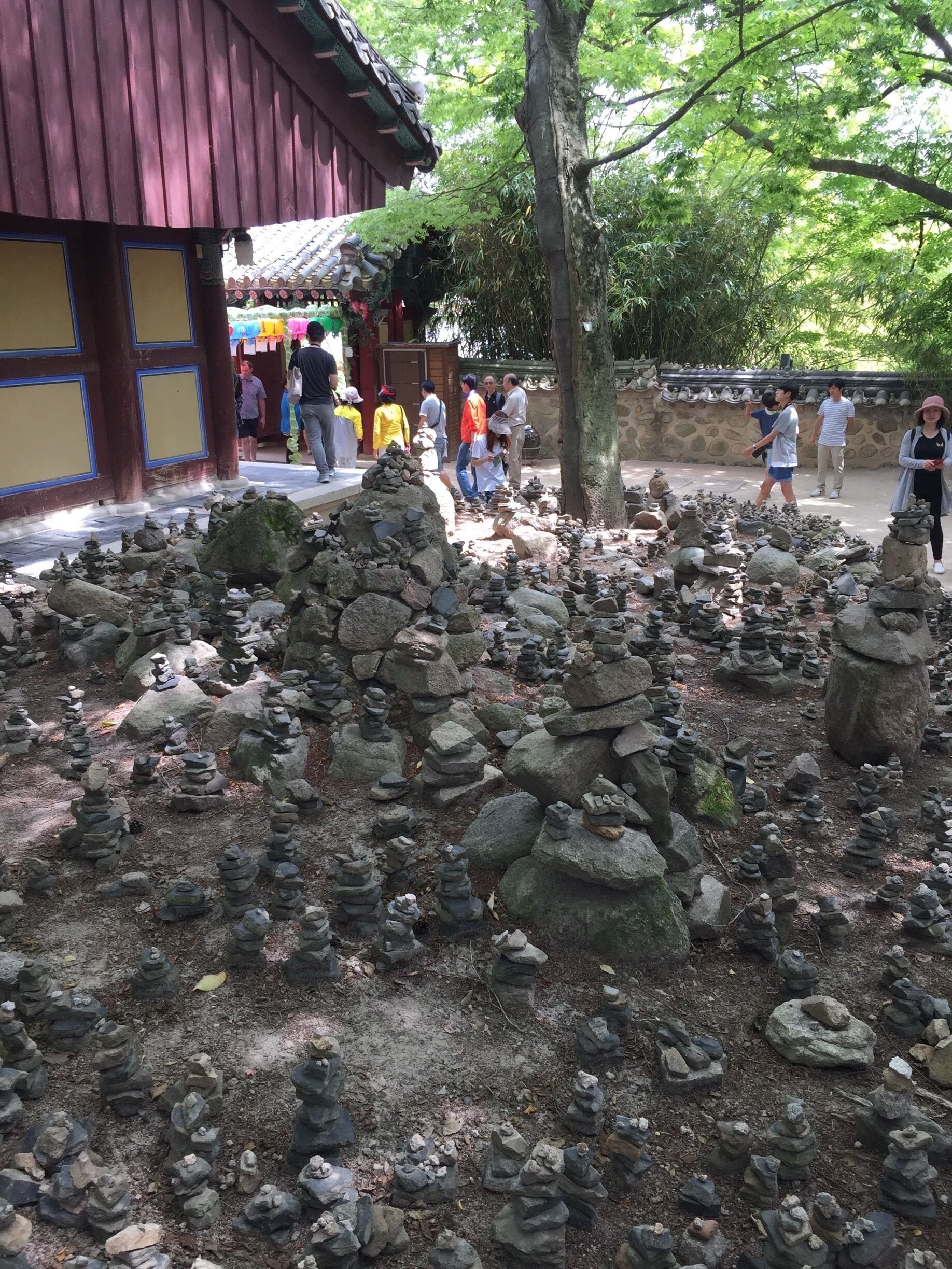 You can find the stacked stones within one of Bulguksa's courtyards. The stacked stones are on the ground and on the surrounding roof tiles topping the walls.